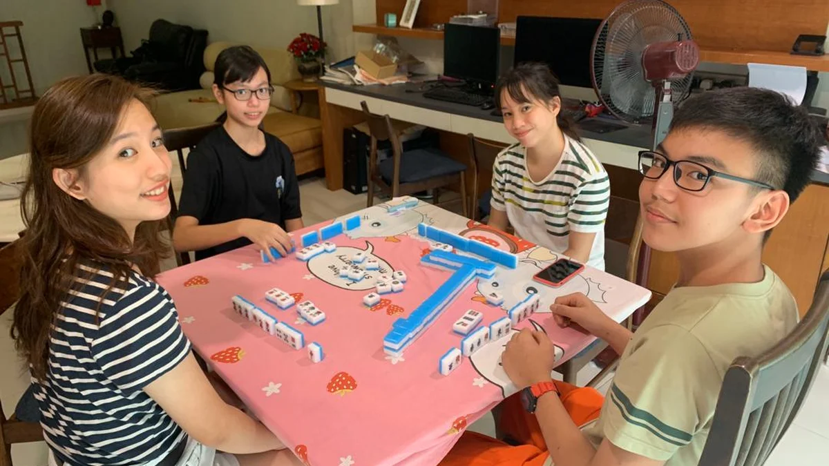 Modern professional mahjong broadcast arena showing electronic table and camera overhead